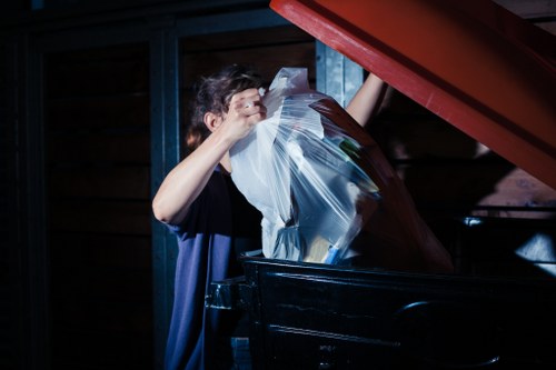 Man and van team loading bulky furniture on a busy high street